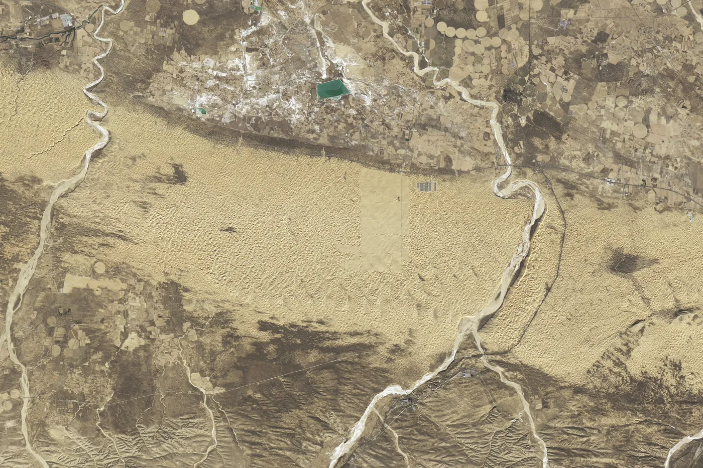 Landsat 8 image from December 2017 of dunes in the Kubuqi Desert south of the Yellow River, with early solar farms.